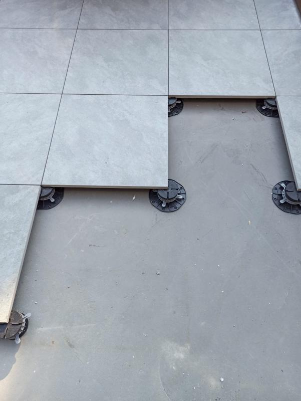 terrace tiles supported on adjustable pedestals