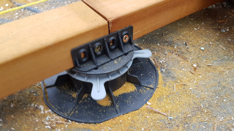 joist mounted to the adjustable pedestal by an adapter